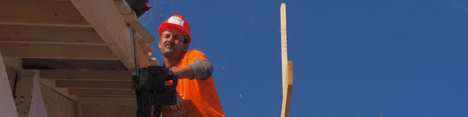 Man working on a wooden roof