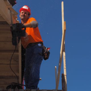 Man working on a wooden roof